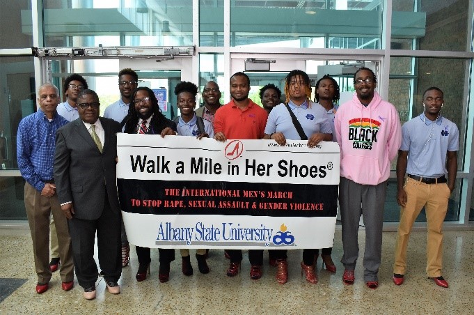 students with holding event sign