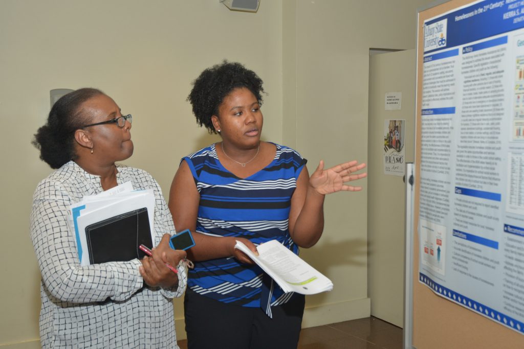 An ASU graduate student presented original research to Louise Wrensford, dean of the ASU Graduate School, at the 2017 Spring Graduate Research Symposium.