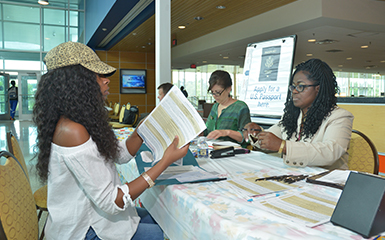 Spot Light on Rams 385 x 240 - Students getting help with Passport Application                   